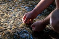 Male european hand refreshing in meditative zen atmosphere in a crystal clear water of a flat little creek with silky ripples