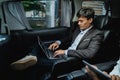 Male executive using laptop while going by car Royalty Free Stock Photo