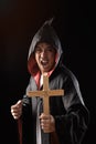 Male exorcist in black coat holding crucifix Royalty Free Stock Photo