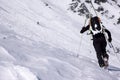 Male extreme skier heading towards a high alpine mountain peak Royalty Free Stock Photo
