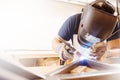 Male in face mask welds with argon-arc welding Royalty Free Stock Photo