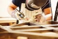 Male in face mask welds with argon-arc welding