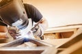 Male in face mask welds with argon-arc welding Royalty Free Stock Photo