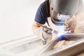 Male in face mask welds with argon-arc welding Royalty Free Stock Photo