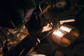 Male in face mask welds with argon welding. Industrial welder worker welding using argon machine, close up. Man working Royalty Free Stock Photo