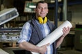 male factory worker holding roll paper