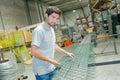 Male factory worker producing fencing