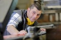 male factory worker using industrial machine