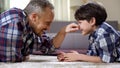 Male family playing on the floor at home, having fun together, weekend leisure Royalty Free Stock Photo