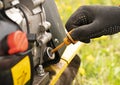male farmer hand check oil level in rotary tiller outdoor