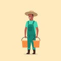 Male farmer holding water buckets african american gardener watering plants working in garden agricultural gardening eco