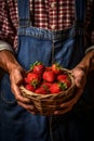 A male farmer holds a strawberry harvest in his hands. Generative AI,