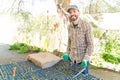 Male Farmer With Seedlings Tray At Farm