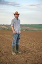 Male Farmer Standing on Fertile Agricultural Farm Land Soil Royalty Free Stock Photo