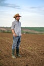 Male Farmer Standing on Fertile Agricultural Farm Land Soil Royalty Free Stock Photo