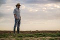 Male Farmer Standing on Fertile Agricultural Farm Land Soil Royalty Free Stock Photo