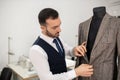 Male fashion designer undoing buttons on jacket