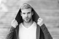 Male fashion influencer. Fashionable young model man. Popular street style. Handsome man with hood standing urban Royalty Free Stock Photo