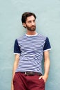 Male fashion model leaning against wall with striped shirt Royalty Free Stock Photo