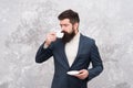 Male fashion model. Mature businessman. elegant man with beard drink coffee. Brutal bearded hipster in formal suit