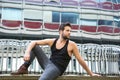 Male fashion model sitting outdoors in urban area Royalty Free Stock Photo