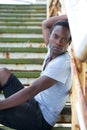 Male fashion model sitting on steps outdoors Royalty Free Stock Photo