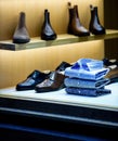 Male fashion store showcase with luxury leather shoes and colorful shirts Royalty Free Stock Photo