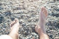 Male feet on the beach. Relaxation