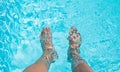 Male feet dipping in swimming pool Royalty Free Stock Photo