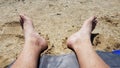 Male feet on sand and pebbles at beach Royalty Free Stock Photo