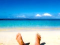 Male feet at the sandy beach Royalty Free Stock Photo