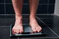 Male feet on the scale