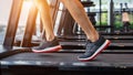 Male feet in sneakers running on the treadmill at the gym. Exercise concept