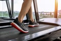 Male feet in sneakers running on the treadmill at the gym. Exercise concept. Royalty Free Stock Photo