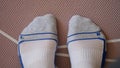 Male feet in socks standing on yoga mat closeup top view Royalty Free Stock Photo