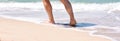 Male feet step on the sea wave. Summer vacations concept.Beach holiday. Banner. Copy space Royalty Free Stock Photo