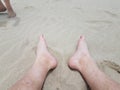 male feet and toes in sand on beach Royalty Free Stock Photo