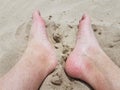 male feet and toes in sand on beach Royalty Free Stock Photo