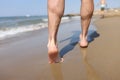 Male feet walking on sand at beach closeup Royalty Free Stock Photo