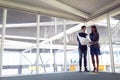 Male and female architects discussing over blueprint in office Royalty Free Stock Photo