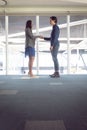 Male and female architects shaking hands with each other in office Royalty Free Stock Photo