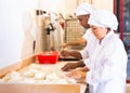 Male and female baker working together in bakery Royalty Free Stock Photo
