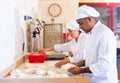 Male and female baker working together in bakery Royalty Free Stock Photo