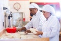 Male and female baker working together in bakery Royalty Free Stock Photo