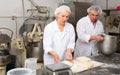 Male and female baker working together in bakery shop Royalty Free Stock Photo