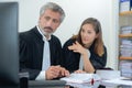 Male and female barristers looking at computer screen