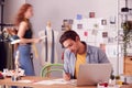 Male And Female Business Owners Working On Designs In Busy Fashion Studio Together Royalty Free Stock Photo