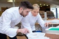 Male and female chefs working with chocolate