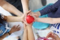 Male female and child hands are holding red heart. Royalty Free Stock Photo