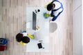 Male And Female Cleaners Cleaning Office Table Royalty Free Stock Photo